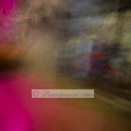 A blurred, abstract street scene with soft pink, green, and brown hues, created using intentional camera movement (ICM), evoking a dreamy and mysterious atmosphere.